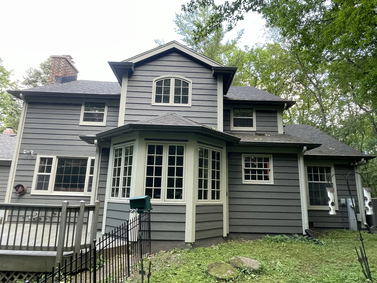Finished dark exterior repaint with cream trim on a Milwaukee-area home